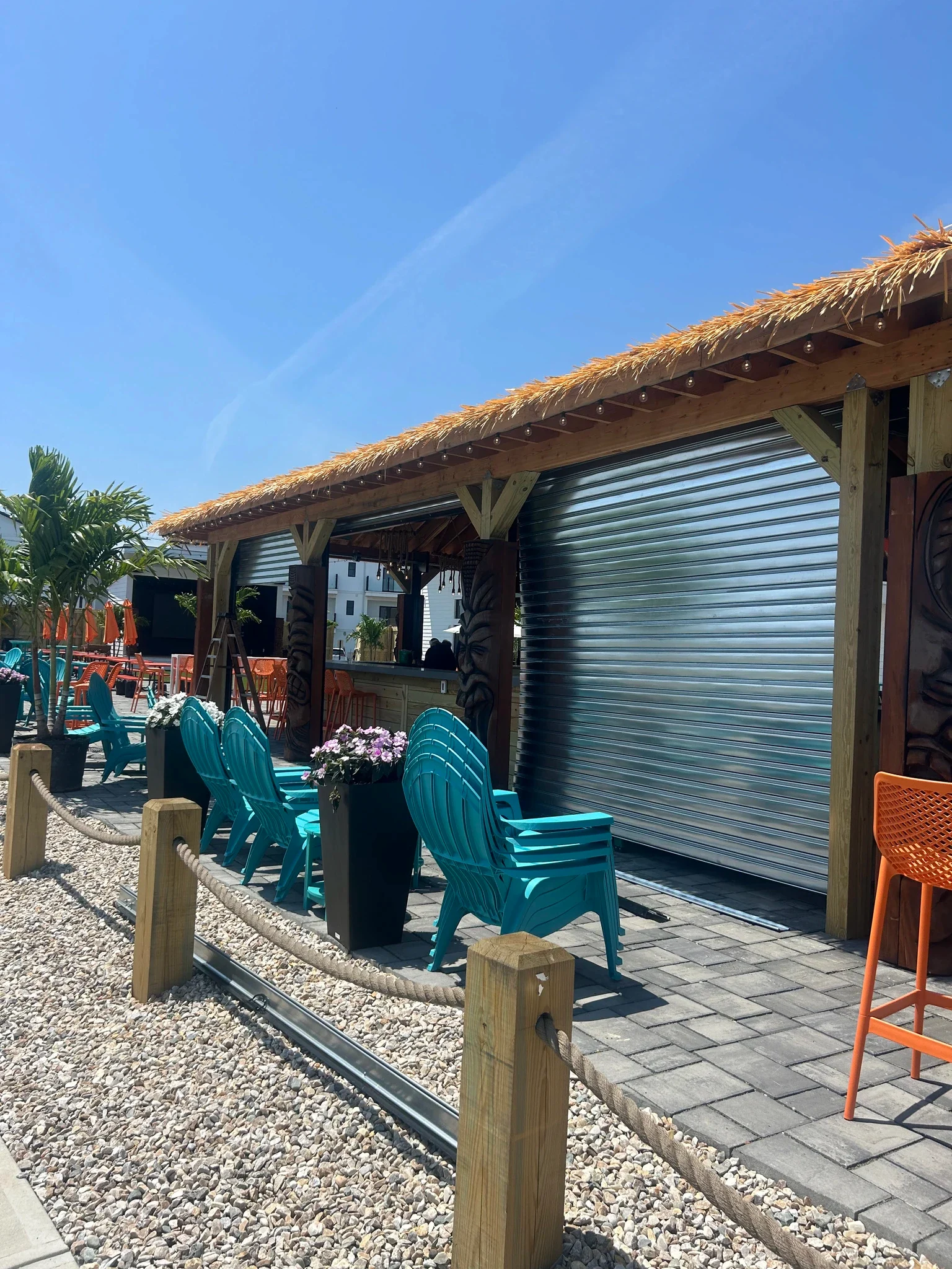 Rolling steel service door installed at an outdoor commercial stall