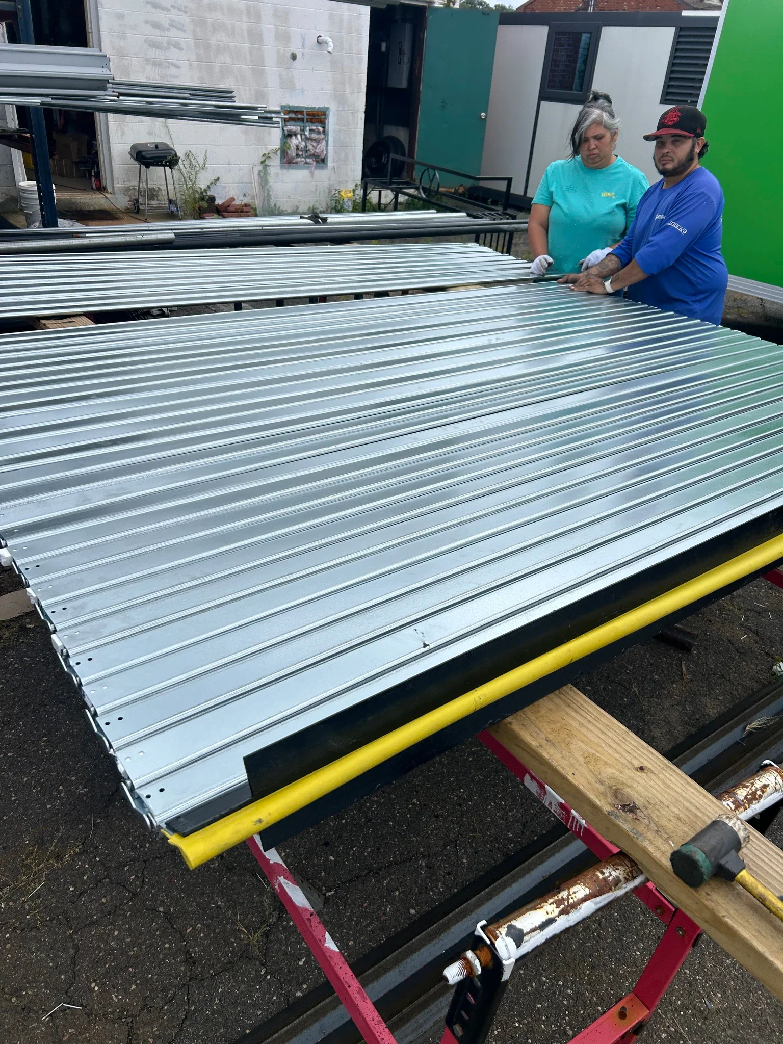 Rolling steel curtain being prepared during field fabrication work