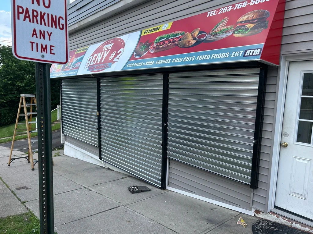 Wide rolling steel door serving a commercial garage opening