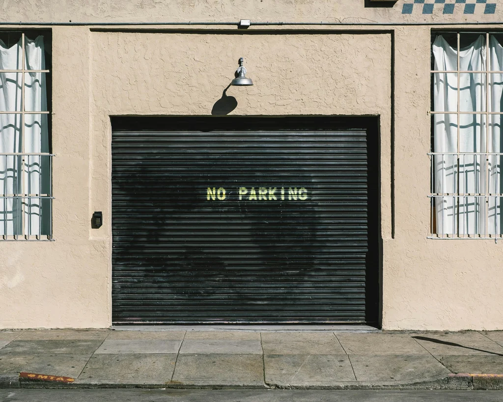 Black commercial roll-up door installed at a Connecticut property