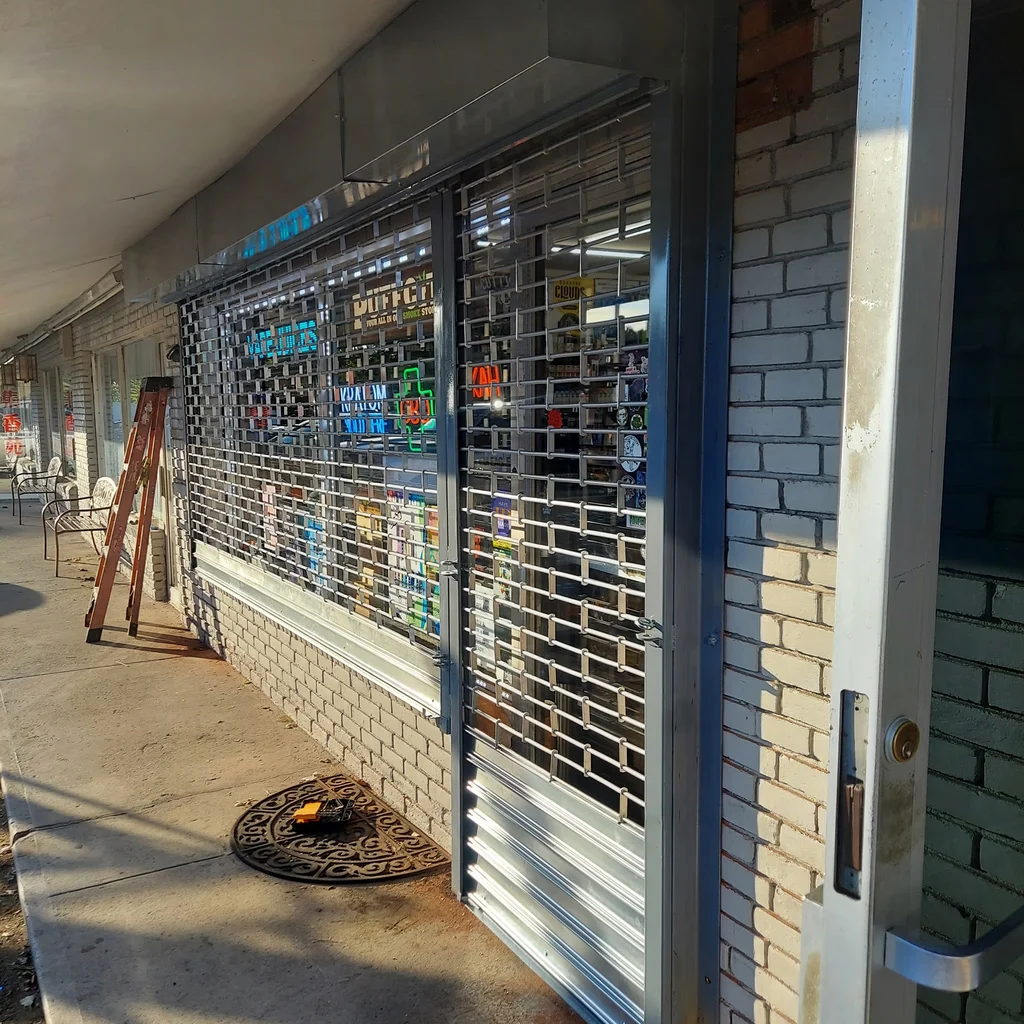 Metal security grille installed across a storefront